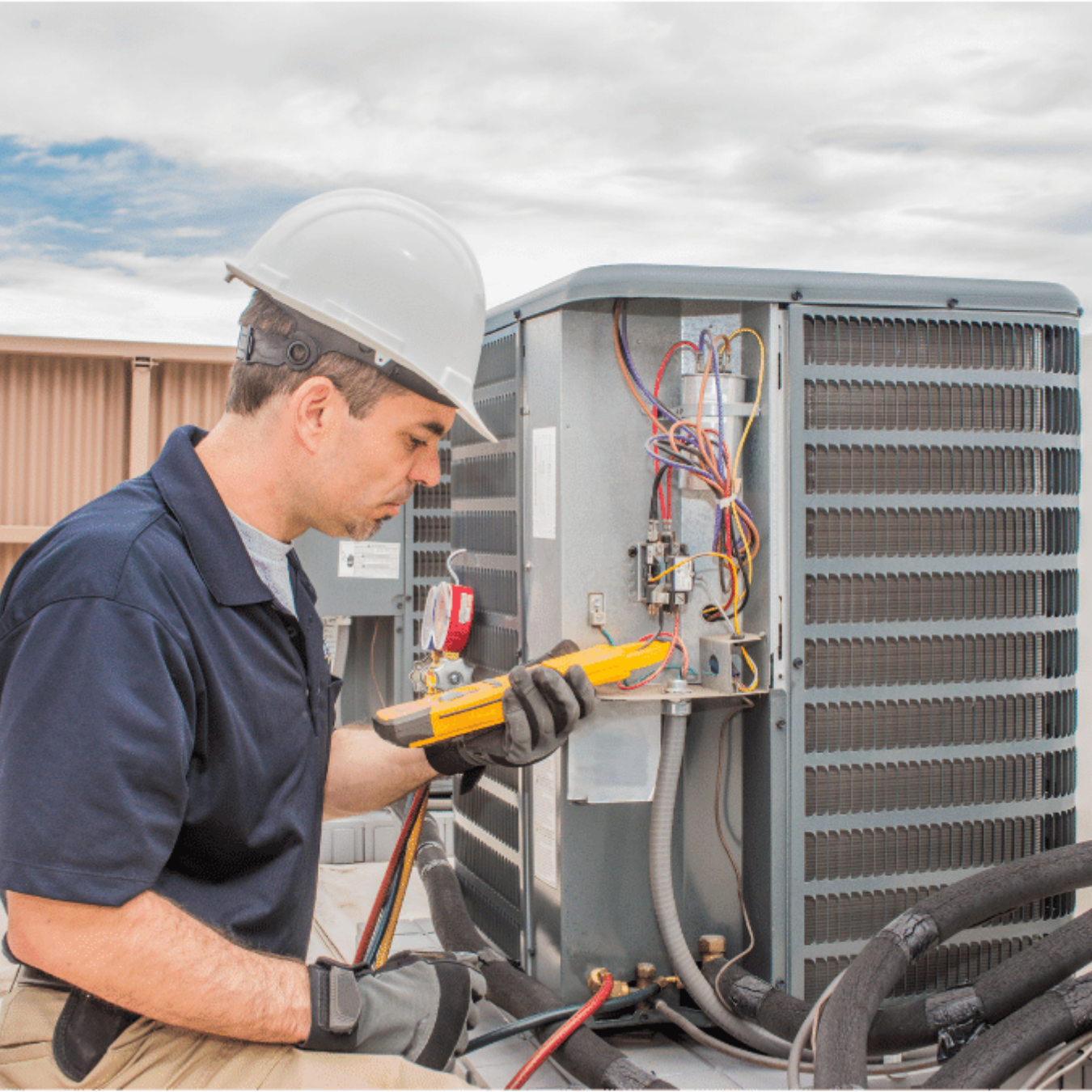 London Furnace Repair technician adjusting a home thermostat in London, Ontario